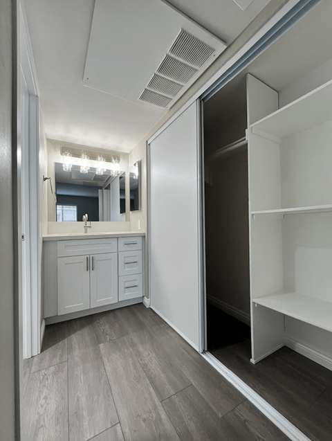 A kitchen with a refrigerator, cabinets, and a countertop.